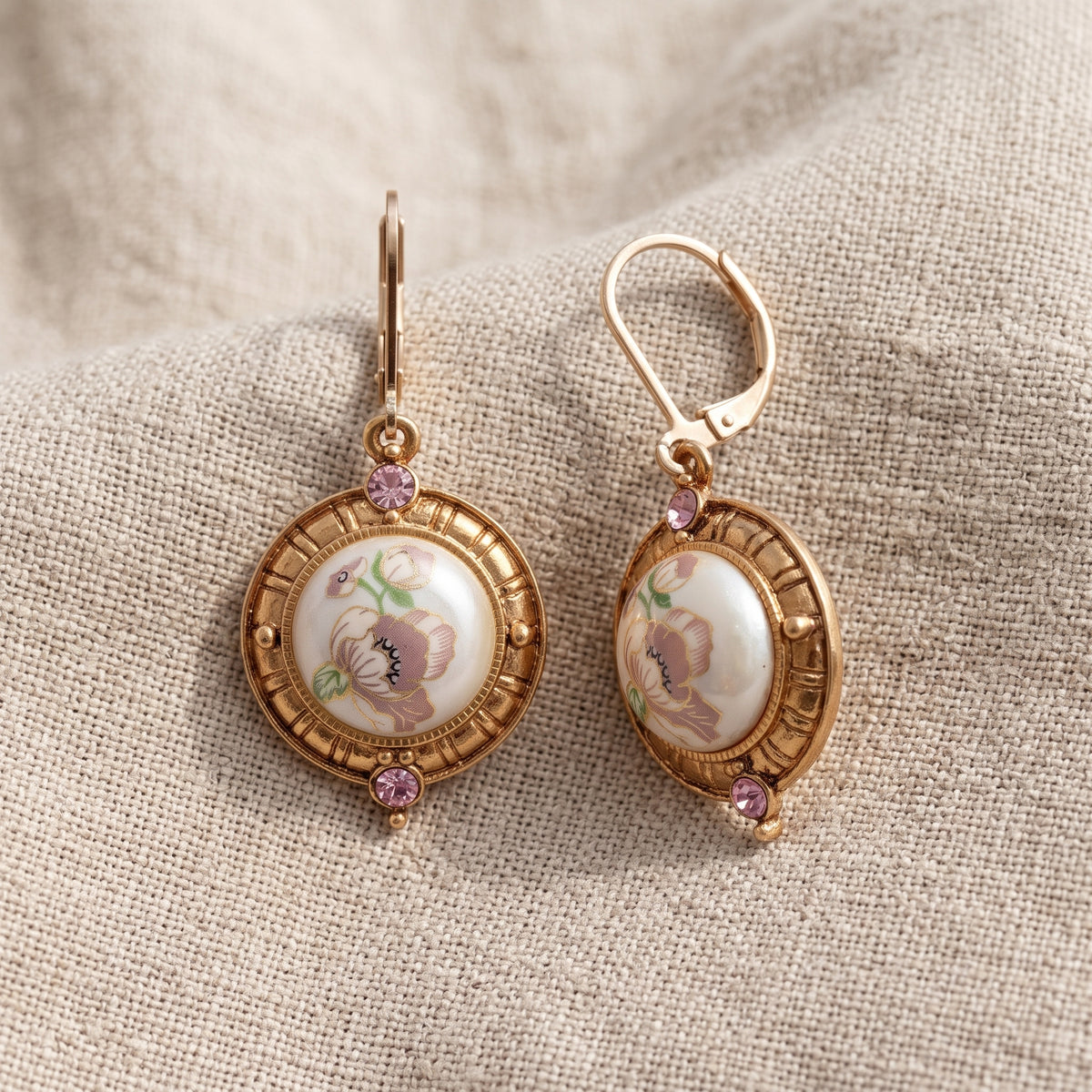 Light Rose Pink Crystal & Faux Pearl Pink Flower Decal Drop Earrings on beige linen
