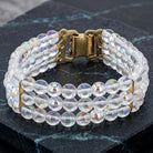 Round Three Row AB Glass Beaded Bracelet resting on dark marble stone surface