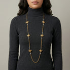 Woman in a dark turtleneck wearing our classic Quadruple Bee AB Crystals Chain Necklace
