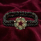 Peacock Plumage Blue Iridescent AB Black Glass Bead Wreath Bracelet resting on dark red fabric 