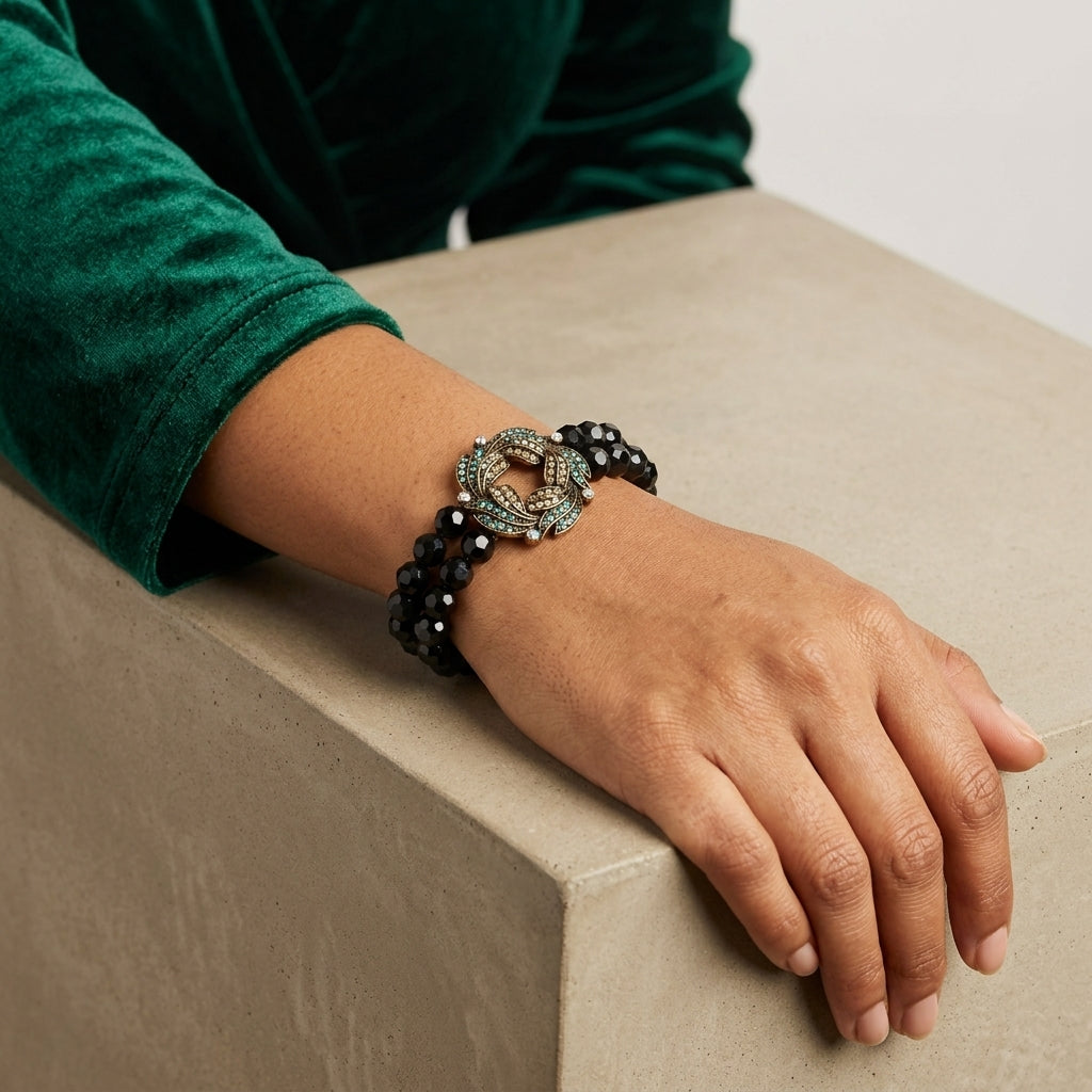 Woman wearing our Peacock Plumage Blue Iridescent AB Black Glass Bead Wreath Bracelet on her wrist