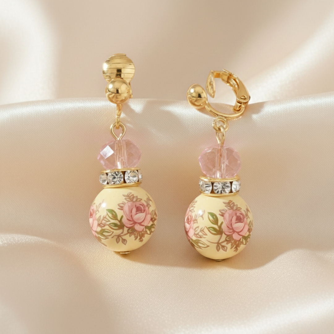 Pair of earrings with floral design on a beige background