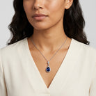 Woman in a white top wearing our Atlantic Blue Stone Teardrop Crystal Pendant Necklace