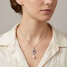 Woman wearing a Siam Red Starburst Crystal Faux Pearl Drop Pendant Necklace