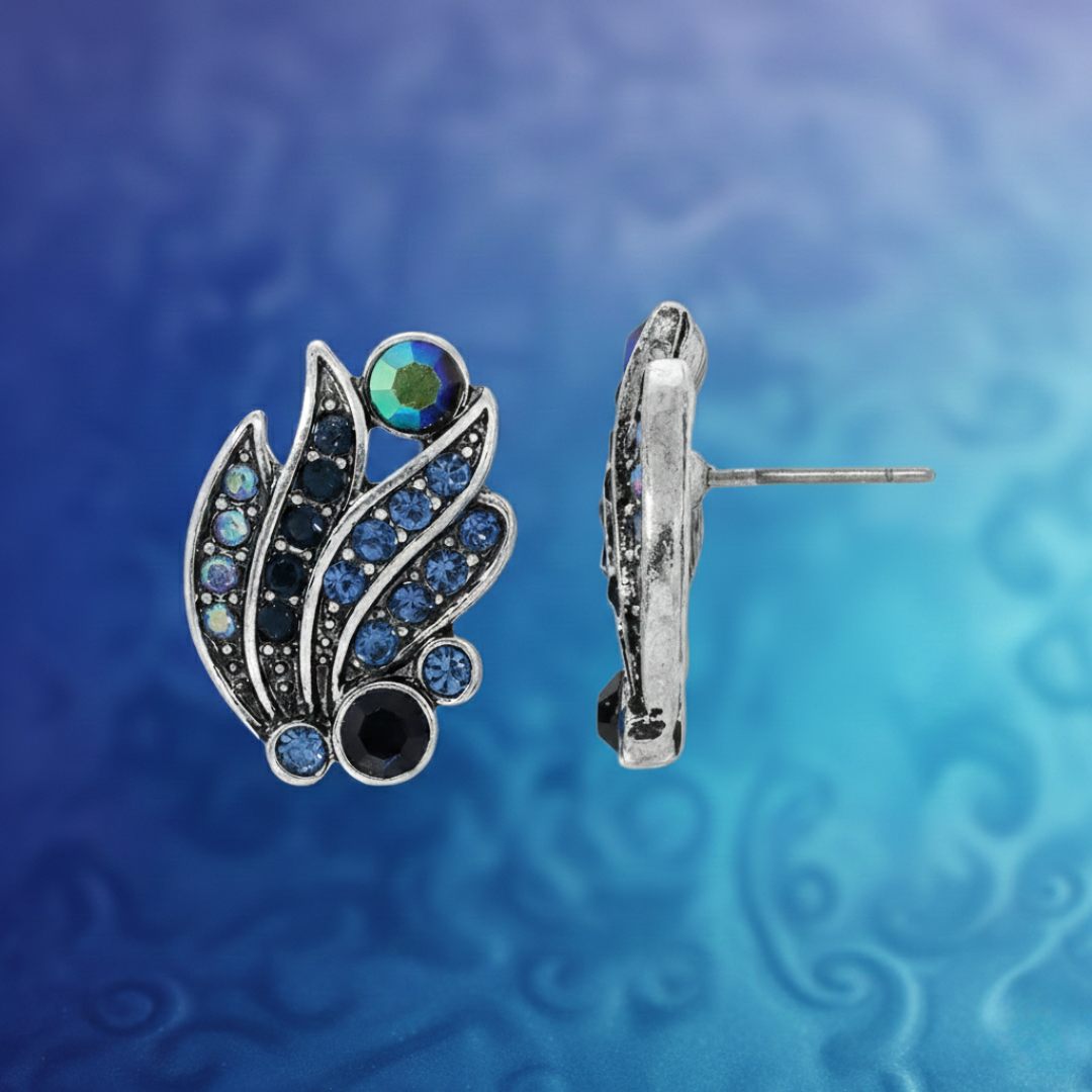 Silver earrings with gemstones on a blue and purple gradient background