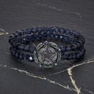 Navy blue double- beaded bracelet with AB crystals on a dark stone surface