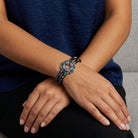 Person wearing a bracelet with AB crystals and an intricate design on a wrist