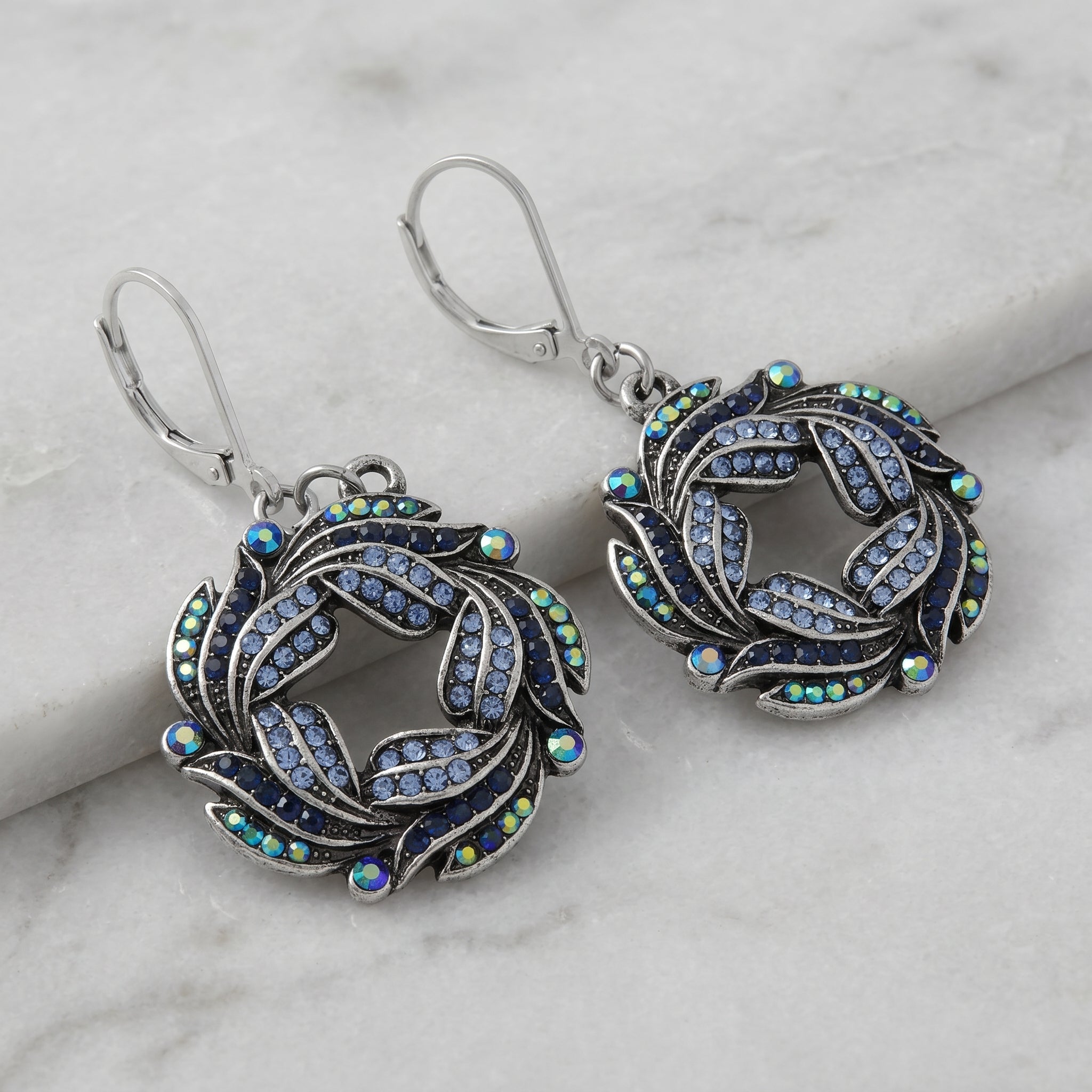 Giovane Iridescent AB Crystal & Blue Stone Wreath Drop Earrings
on a marble surface