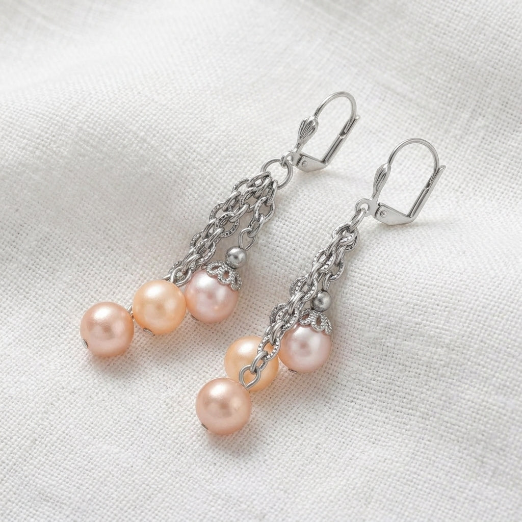 Rosabella Multicolor Faux Pearl Chain Dangle Earrings resting on white linen