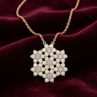 Necklace with a crystal snowflake pendant on a burgundy fabric background