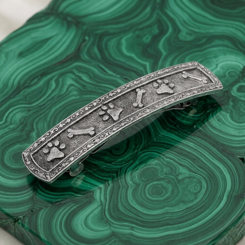 Decorative hair barrette with paw and bone designs on a green malachite stone
