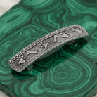 Decorative hair barrette with paw and bone designs on a green malachite stone