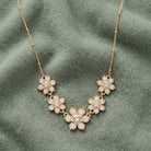 Opal Radiance Stone & Crystal Flower Drop Necklace 16" + 3" Extension displayed on sage green fabric