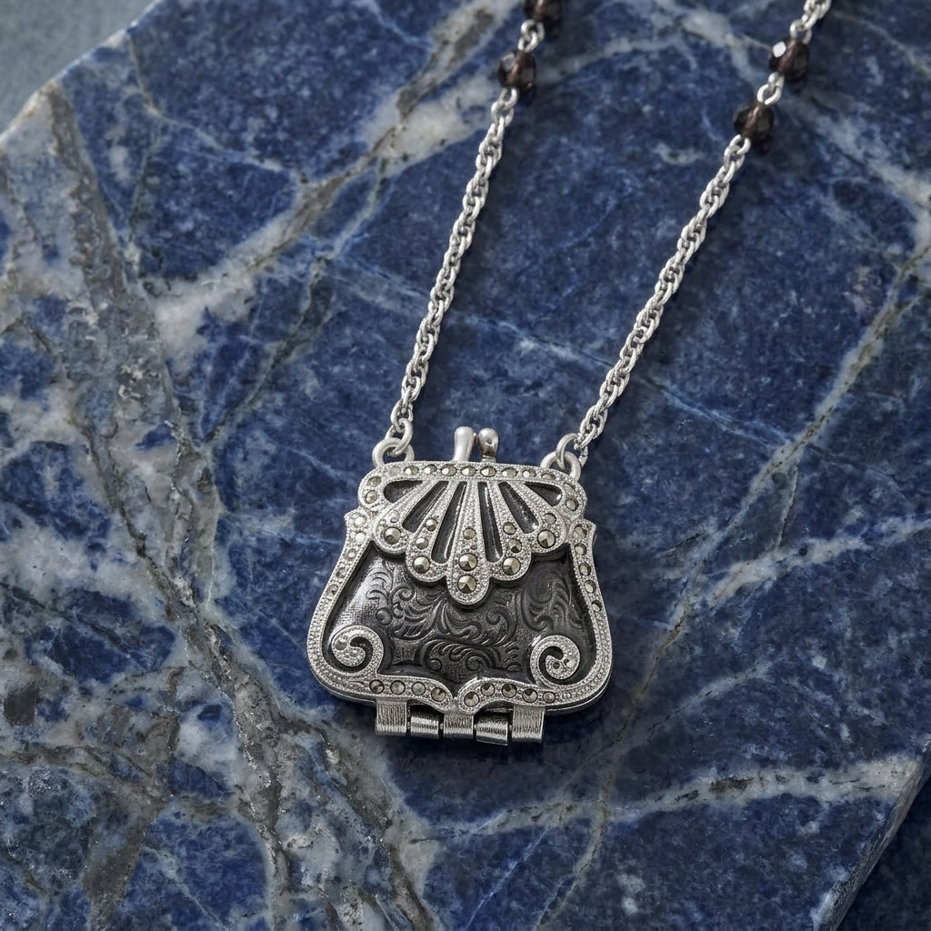 Art Deco-inspired clutch purse pendant necklace with crystal beads on a blue marble surface