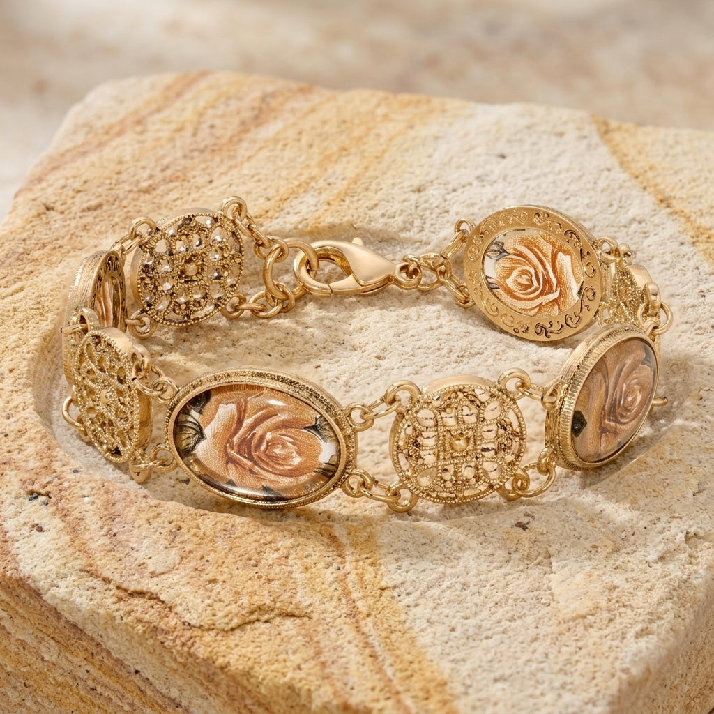 Gold bracelet with rose designs on a textured stone surface