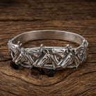 Silver bracelet with racing horse designs on a wooden surface