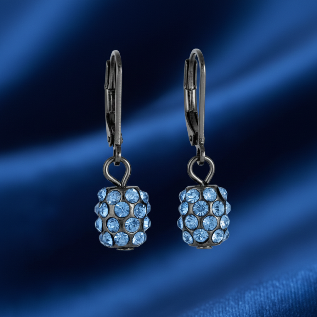 Pair of earrings with blue gemstones on a blue background
