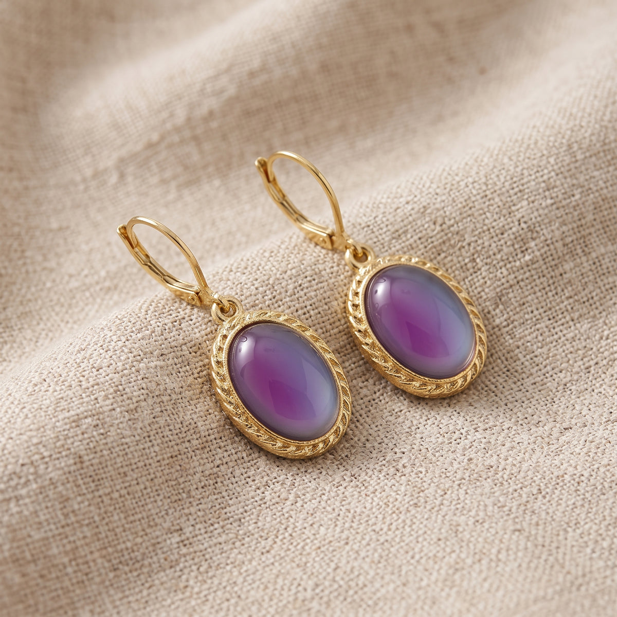 Pink Oval Moonstone Drop Earrings on beige linen