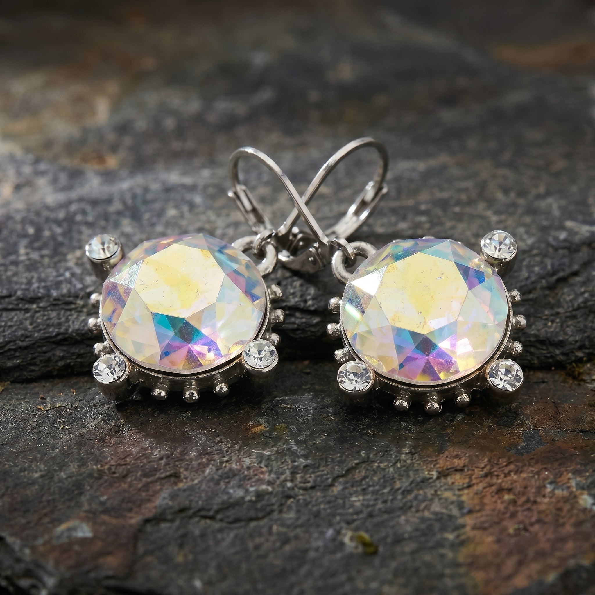 Round AB Austrian Crystal Drop Earrings resting on dark stone surface