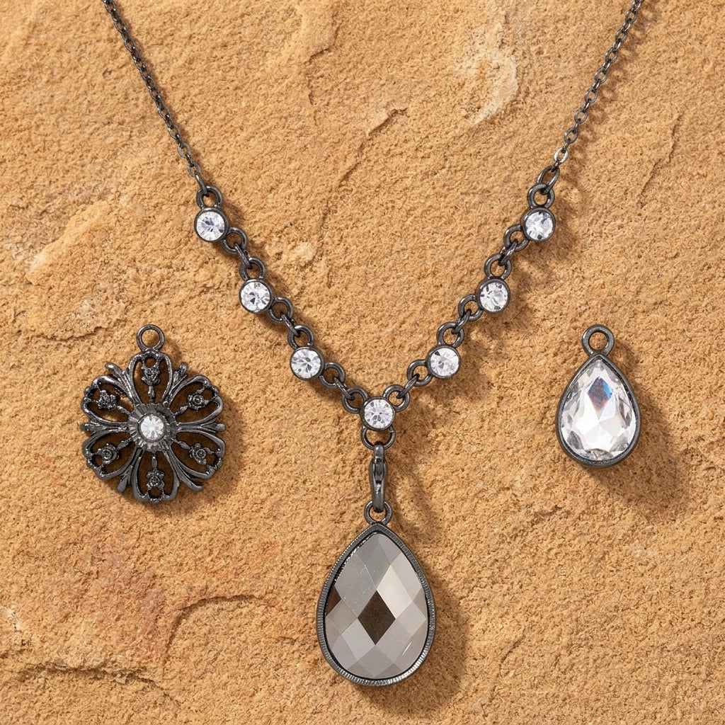 Necklace with three interchangeable pendants on a sandstone surface
