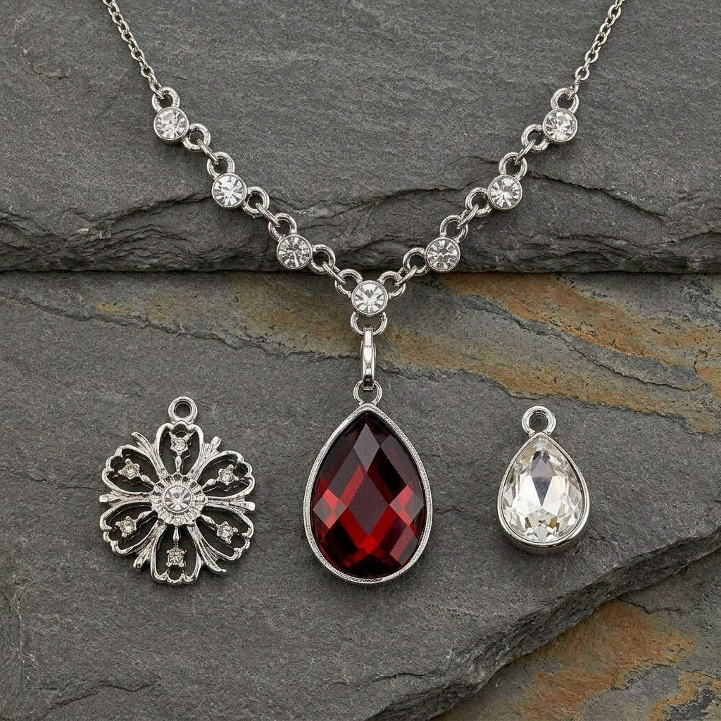 Necklace with three interchangeable pendants on a dark stone surface