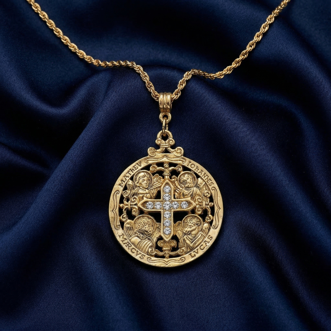 Gold necklace with a detailed pendant on a blue fabric background