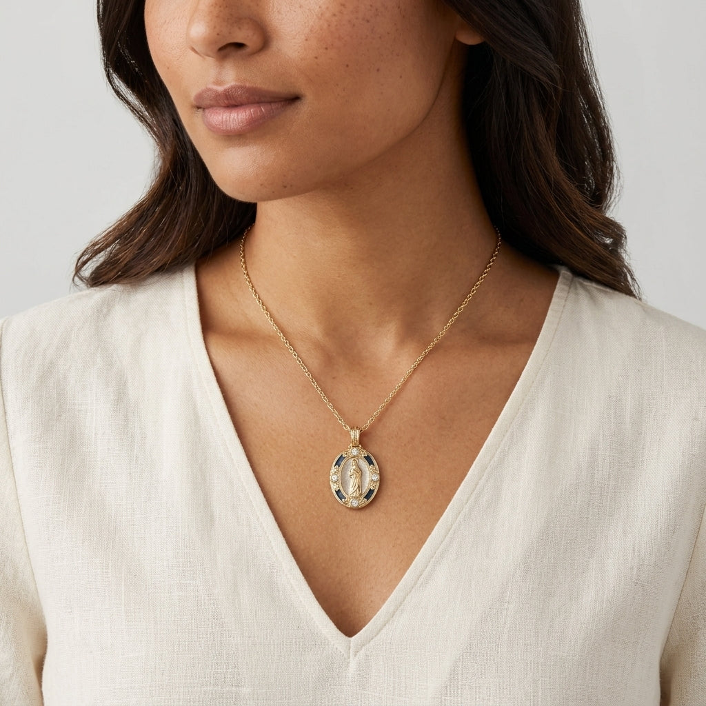 Woman wearing a gold necklace with a religious pendant and crystal accents against a neutral background