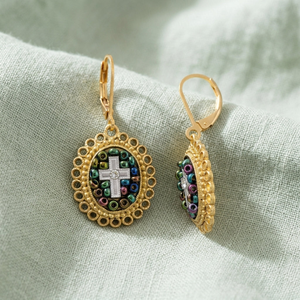 Multi Color Seeded Beads & Crystal Cross Drop Earrings on a light fabric background