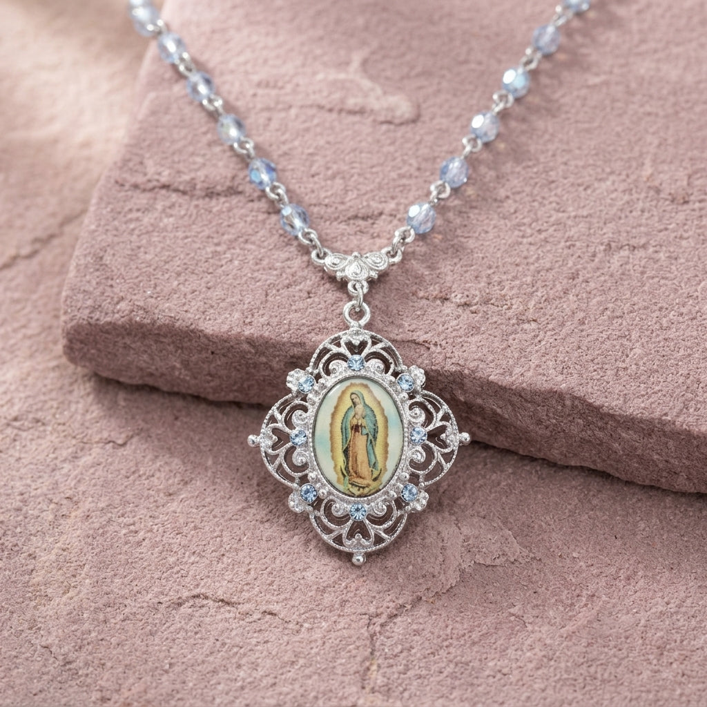 Necklace with a pendant featuring an image of Our Lady of Guadalupe on a pink stone surface