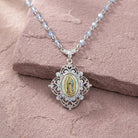 Necklace with a pendant featuring an image of Our Lady of Guadalupe on a pink stone surface