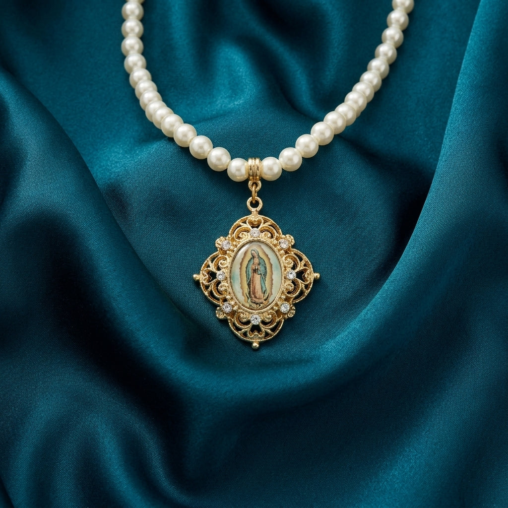 Pearl necklace with a gold Our Lady of Guadalupe pendant on teal fabric