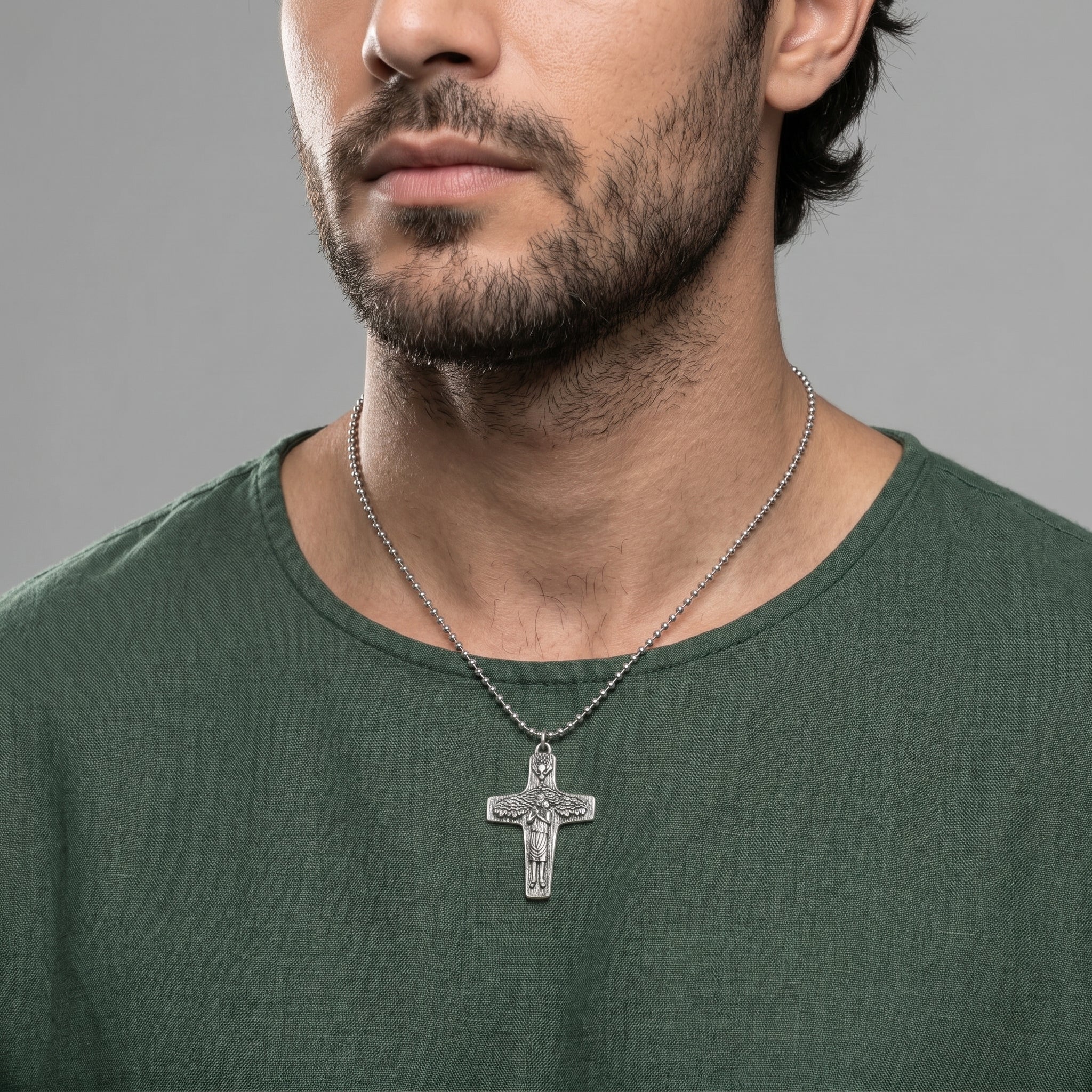 Man wearing a silver tone cross necklace