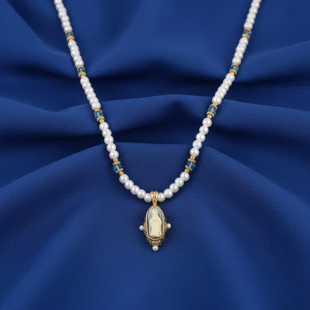 Pearl necklace with a religious pendant on a blue fabric background