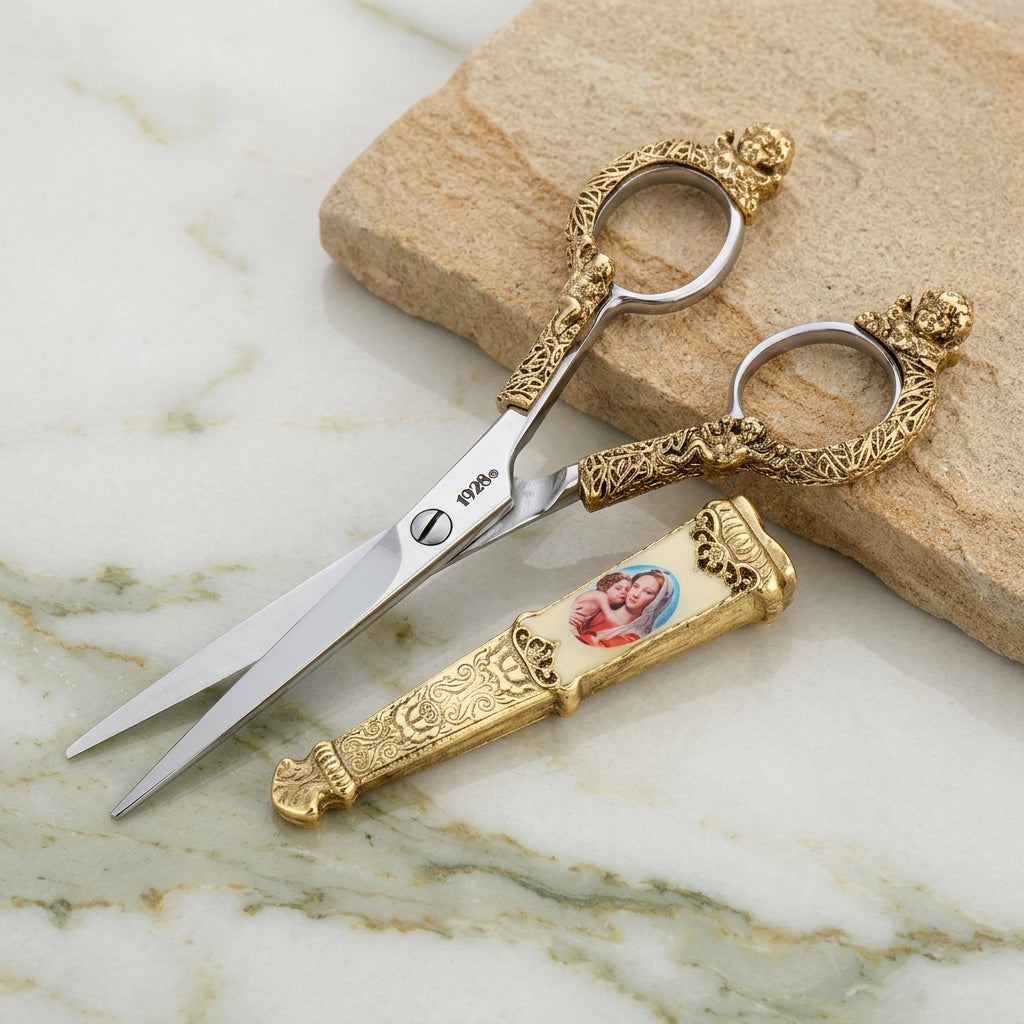Decorative Mother Mary and Child scissors with gold tone handles on a marble surface