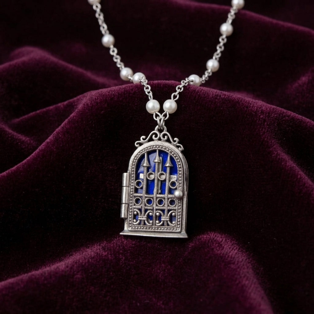 Necklace with a functional gate and cross locket on a dark purple fabric background