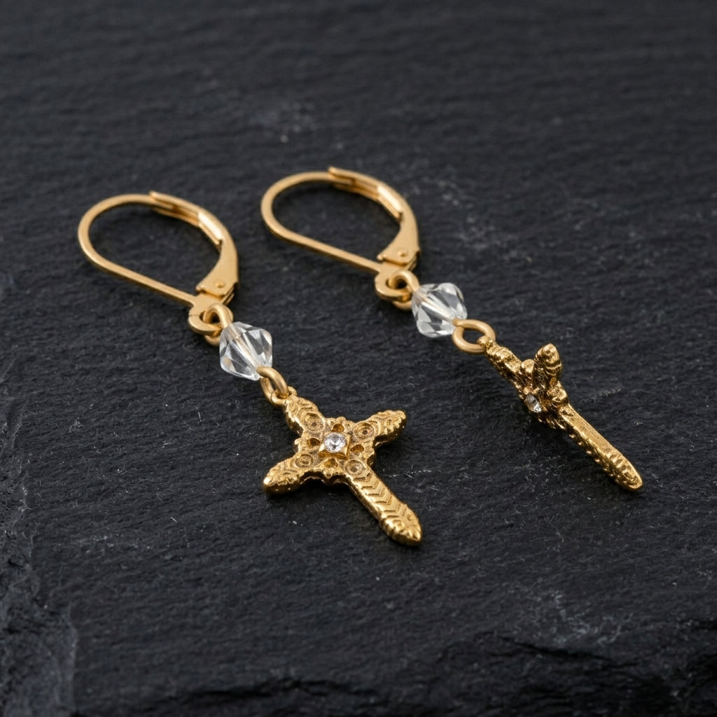 Ornate Cross With Crystal & Lantern Bead Dangling Earrings on a dark stone background