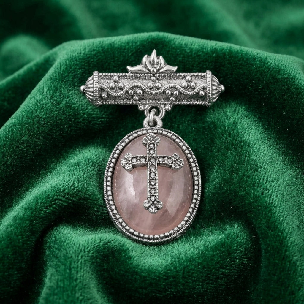 Decorative brooch with cross design on a green fabric background