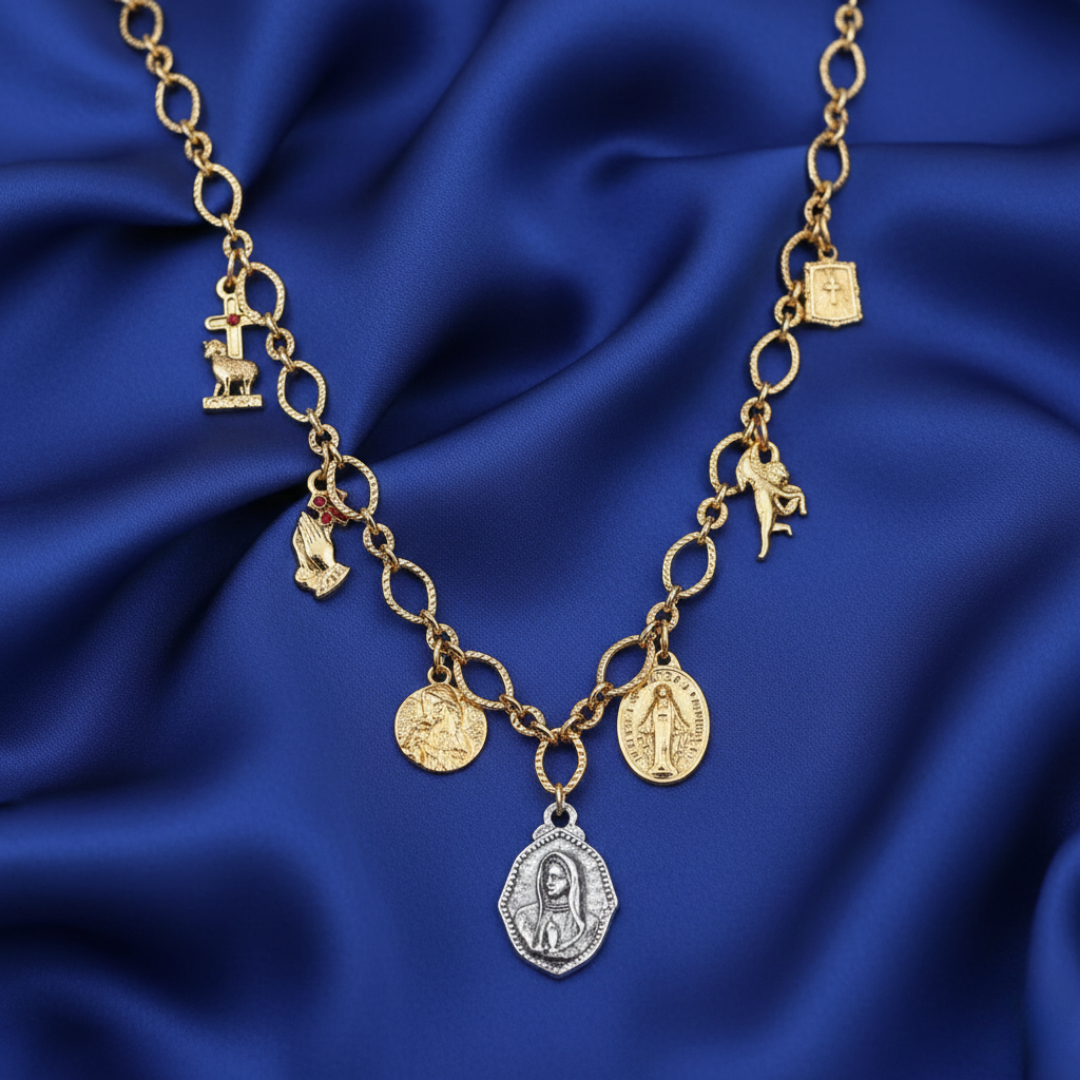 Gold necklace with charms on a blue satin background