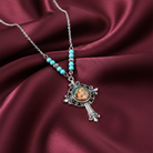 Necklace with a pendant featuring a religious icon on a maroon fabric background