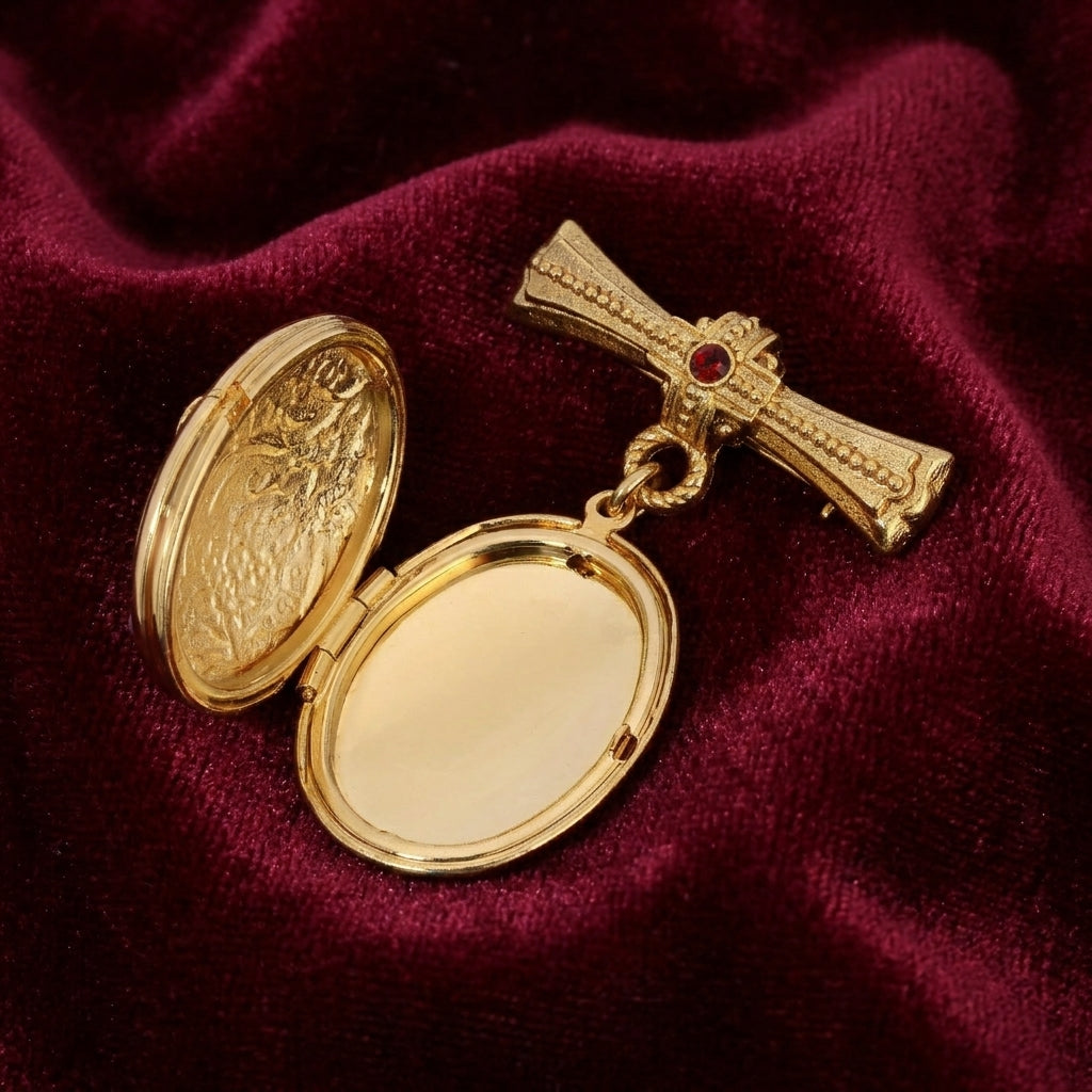 Gold cross brooch locket in opened position with red gemstones on a red fabric background