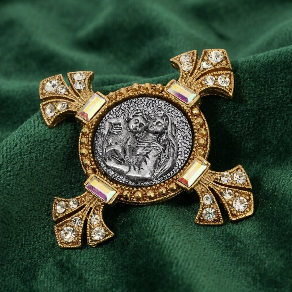 Decorative religious brooch with gold and silver design on a green fabric background