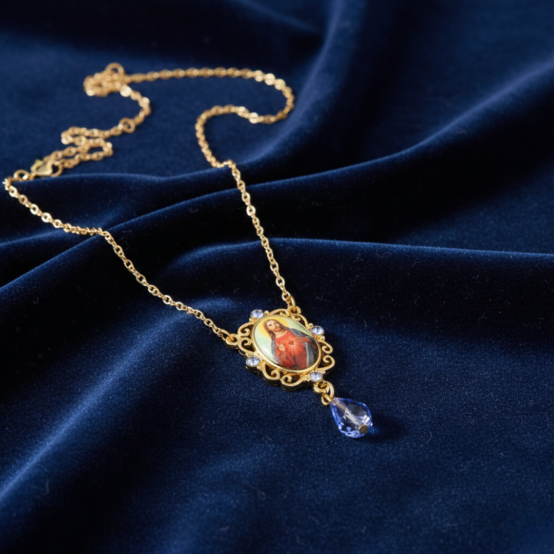 Gold necklace with a Jesus pendant on a blue fabric background