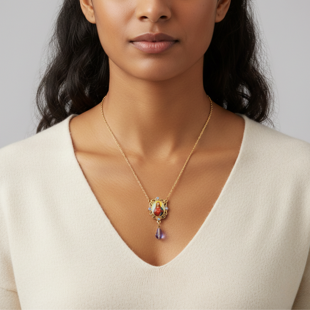 Woman wearing a gold necklace with a colorful Jesus pendant against a neutral background