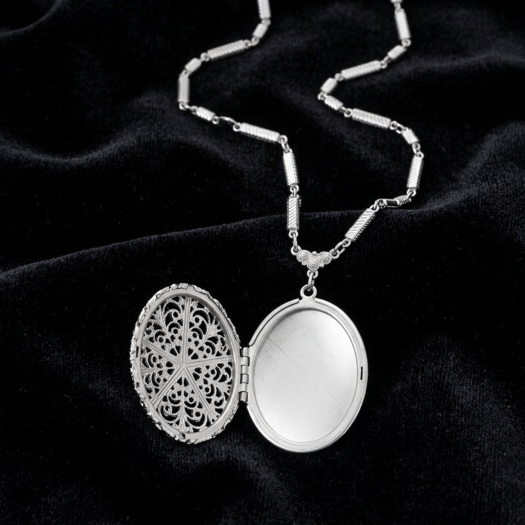 Silver locket with intricate Virgin Mary design on a black background