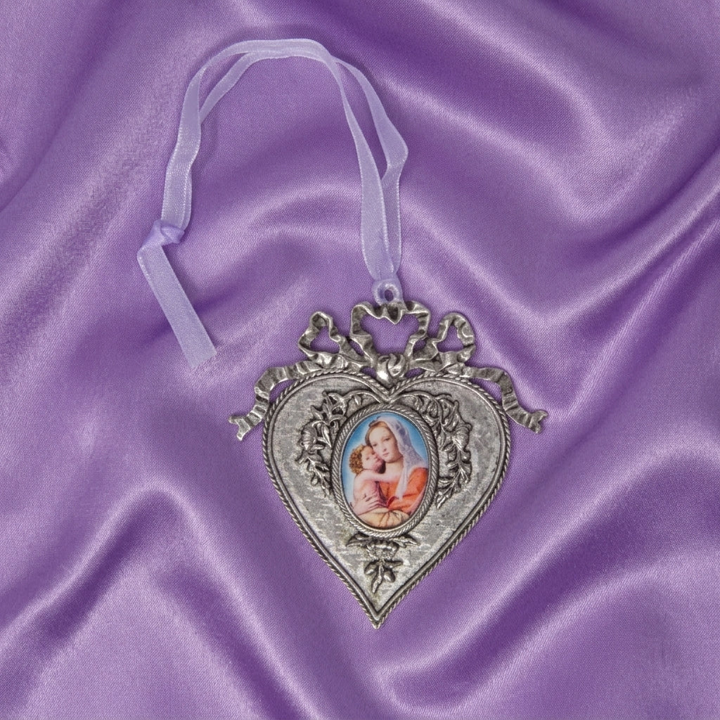 Decorative heart-shaped ornament with a Mother Mary and Child decal on a purple satin background