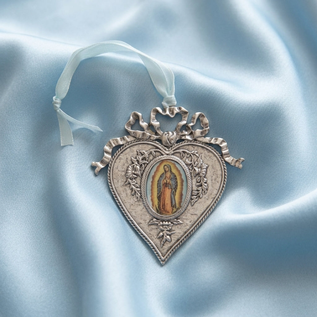 Decorative heart-shaped ornament with Our Lady of Guadalupe on a light blue satin background