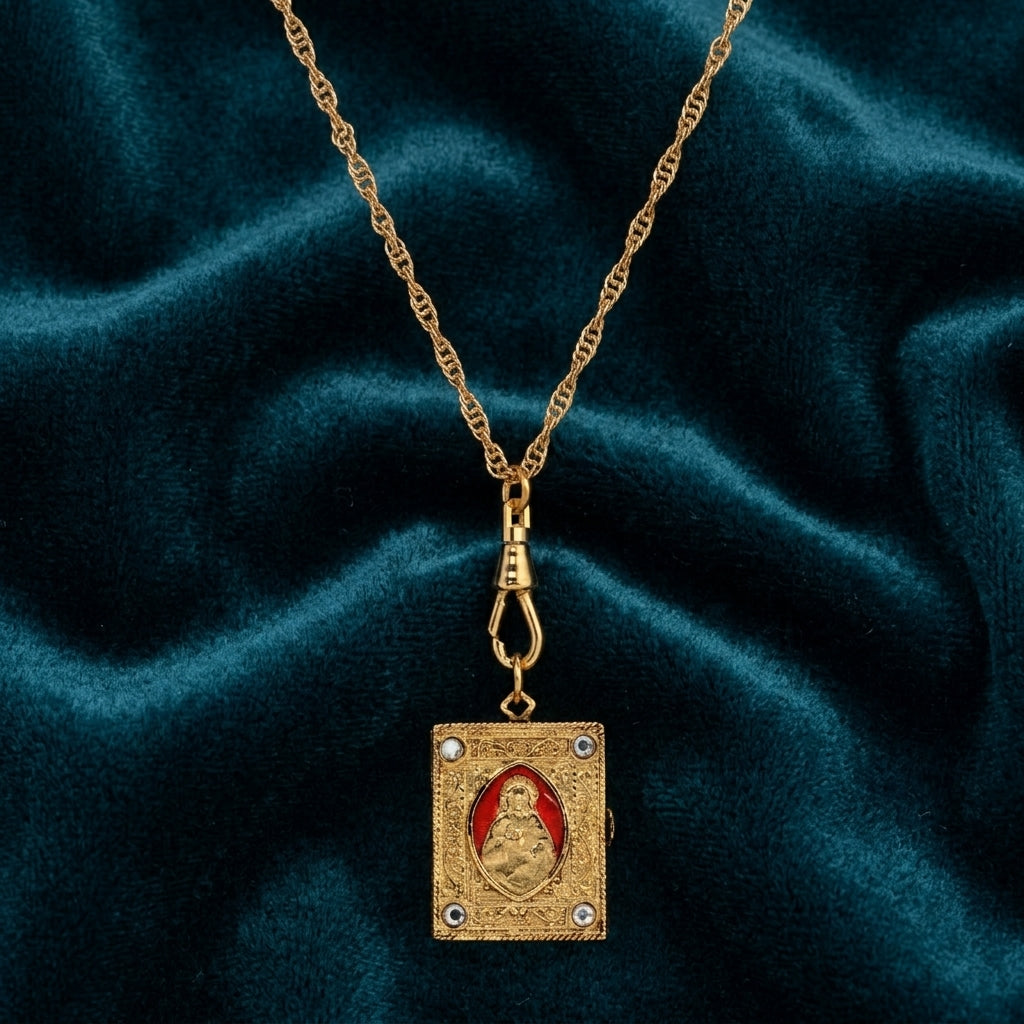 Gold necklace with a bible pendant on a dark blue fabric background