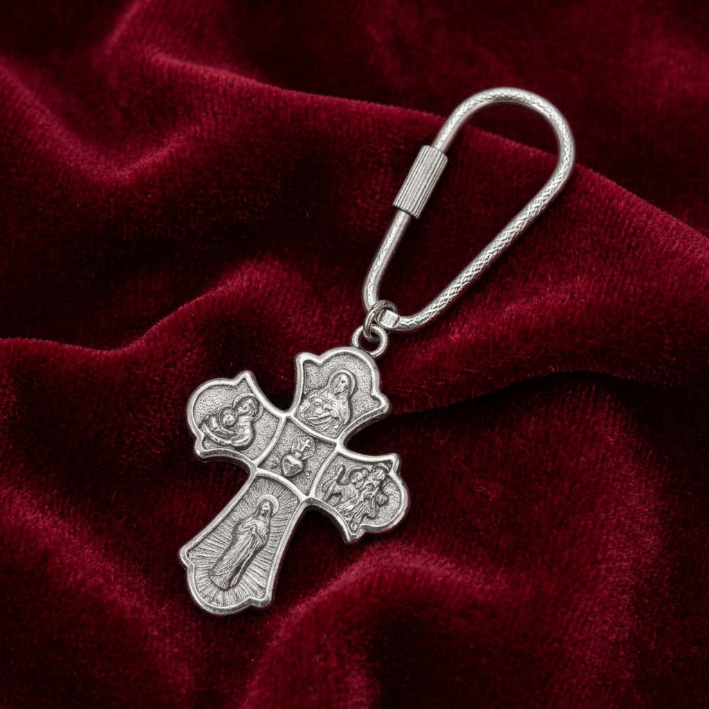 Silver holy family keychain on red satin fabric