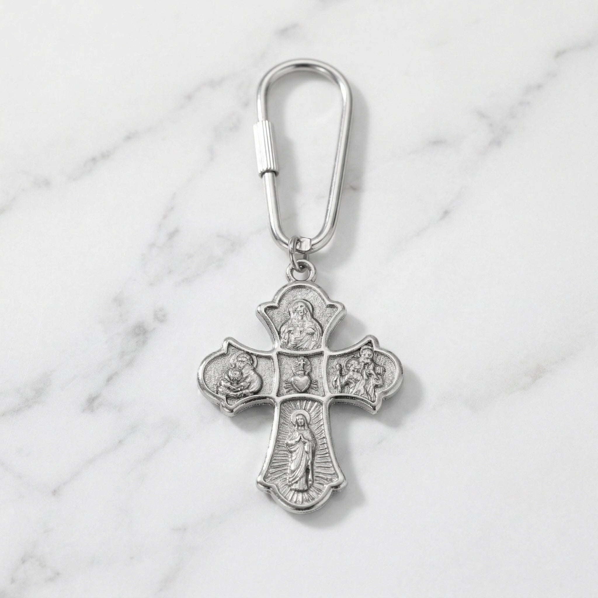 Silver holy family keychain on marble