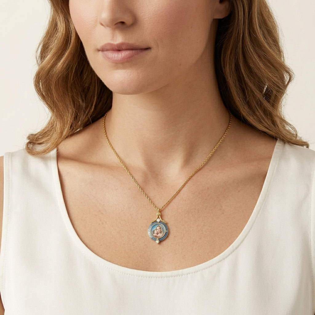 Woman wearing a gold necklace with a Mother Mary and Child pendant on a plain background